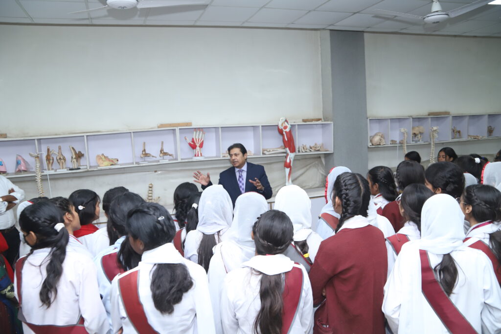 Christian students in Pakistan observing scientific experiments and learning about medical technology in a lab setting.